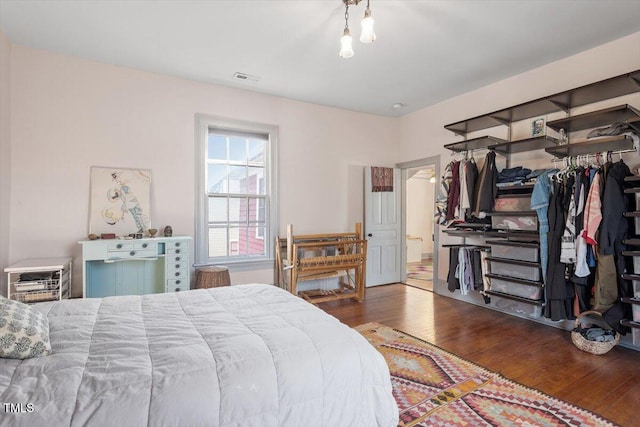 bedroom with wood-type flooring and visible vents