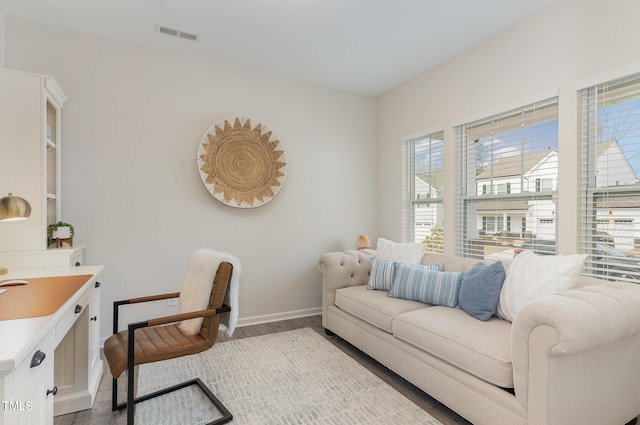 interior space featuring visible vents, baseboards, and wood finished floors