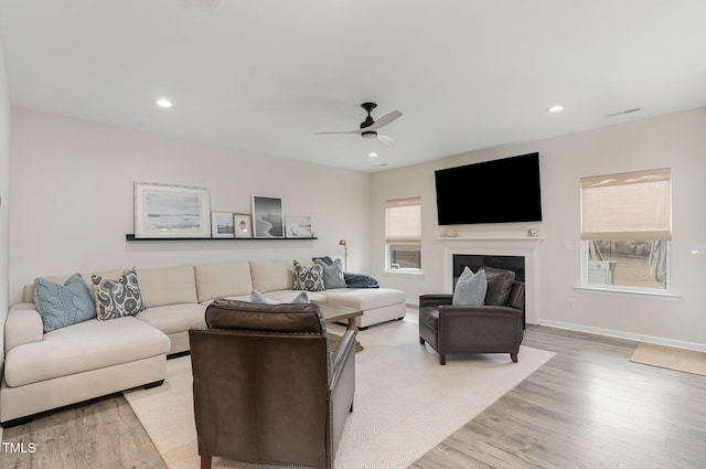 living room featuring recessed lighting, a healthy amount of sunlight, and light wood-style flooring