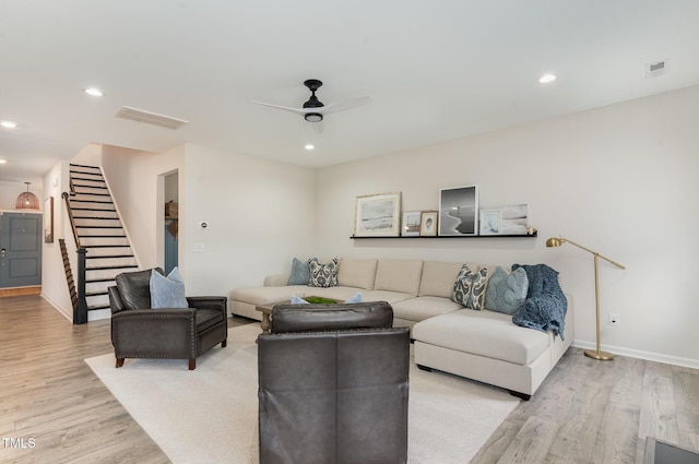 living area with light wood finished floors, stairs, visible vents, and recessed lighting