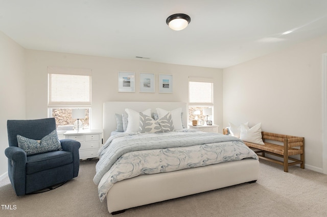 bedroom with carpet, visible vents, and baseboards