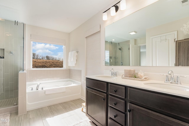 bathroom with visible vents, a stall shower, a sink, and a bath