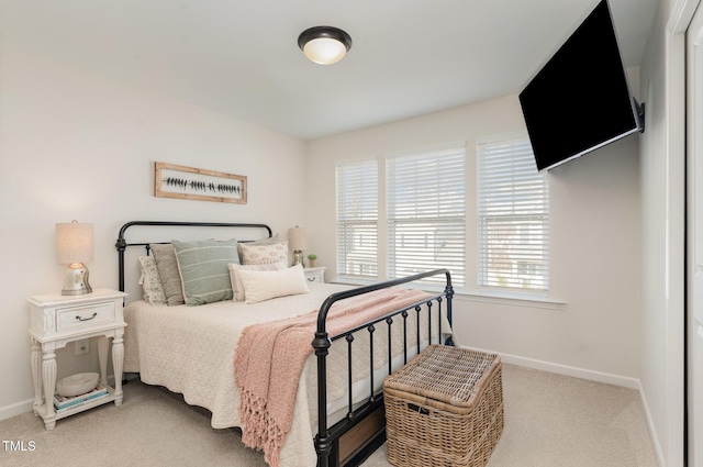 bedroom featuring carpet and baseboards