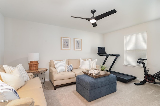 carpeted living room featuring ceiling fan and baseboards