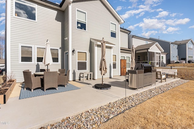 rear view of property with a residential view, fence, outdoor dining area, and a patio