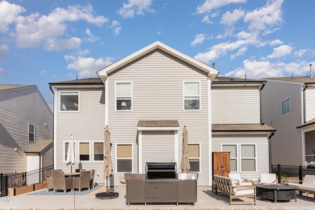 rear view of house featuring an outdoor living space with a fire pit, a patio area, and fence