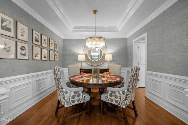 dining room with a notable chandelier, a wainscoted wall, wallpapered walls, and dark wood-type flooring