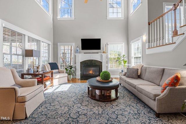 living area featuring a fireplace, wood finished floors, and baseboards