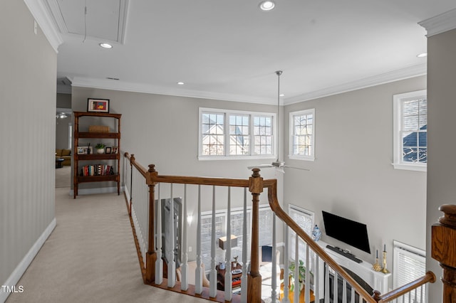 corridor with an upstairs landing, plenty of natural light, light colored carpet, and attic access