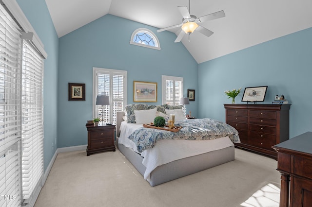 bedroom featuring light carpet, baseboards, high vaulted ceiling, and a ceiling fan