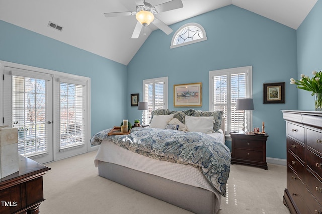 bedroom featuring access to exterior, multiple windows, light colored carpet, and visible vents