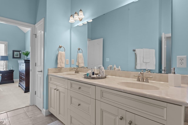 bathroom featuring tile patterned flooring, double vanity, and a sink