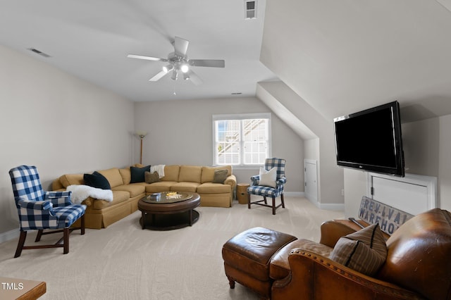 living area featuring visible vents, light colored carpet, baseboards, and ceiling fan