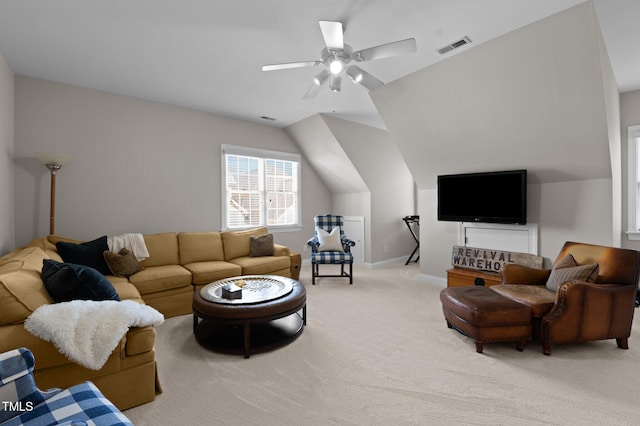 living area featuring a ceiling fan, baseboards, visible vents, vaulted ceiling, and light carpet