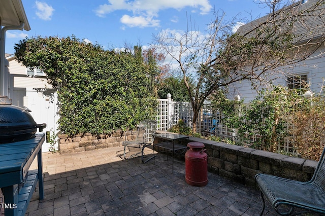 view of patio / terrace featuring fence