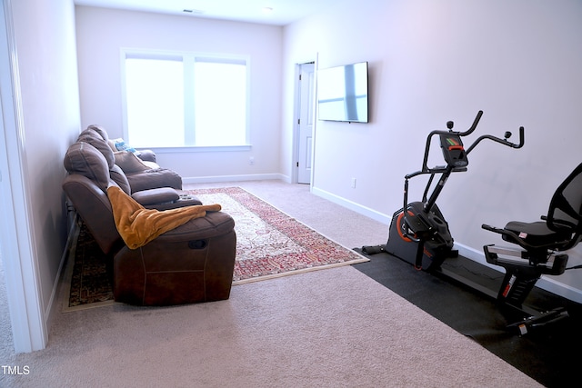 exercise area featuring carpet, visible vents, and baseboards