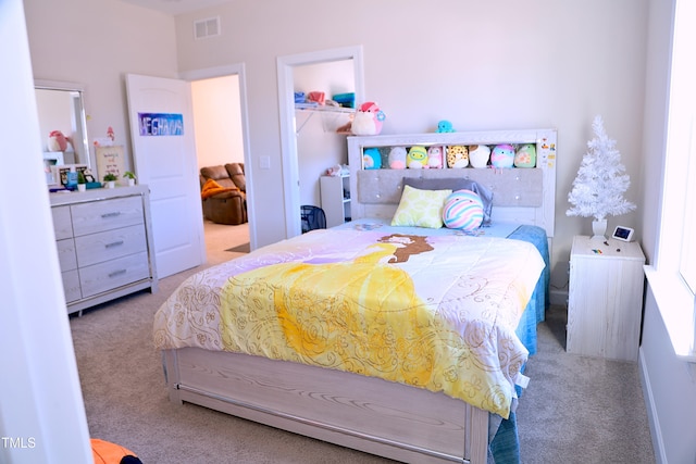 bedroom featuring carpet, visible vents, and a closet