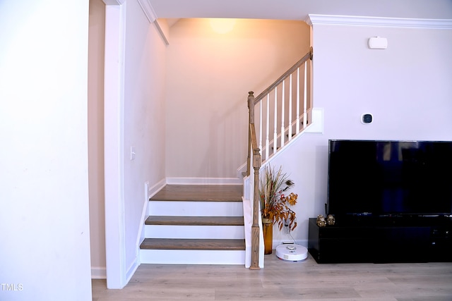 stairway featuring baseboards and wood finished floors