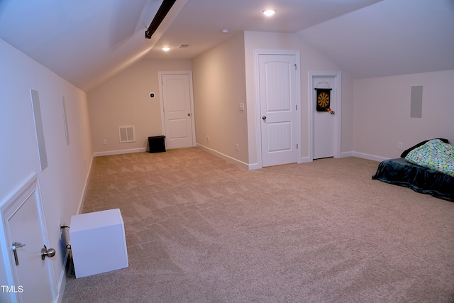 carpeted bedroom featuring lofted ceiling, baseboards, and visible vents