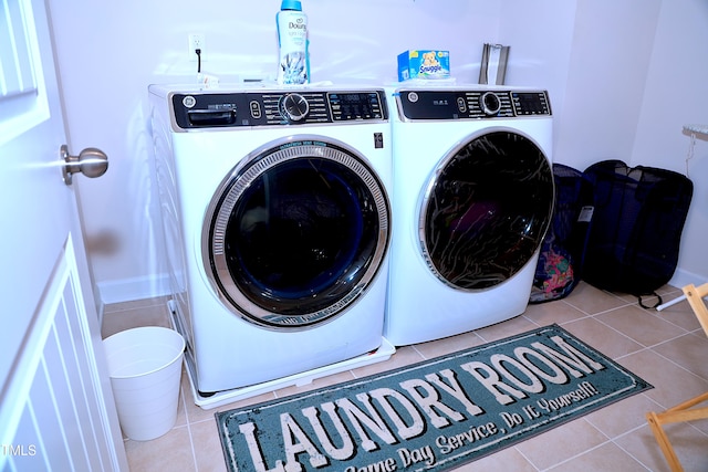 laundry room with laundry area, separate washer and dryer, and tile patterned flooring