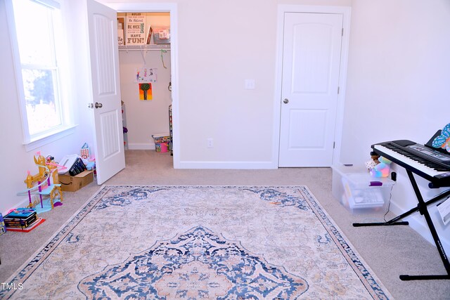 rec room featuring carpet flooring and baseboards