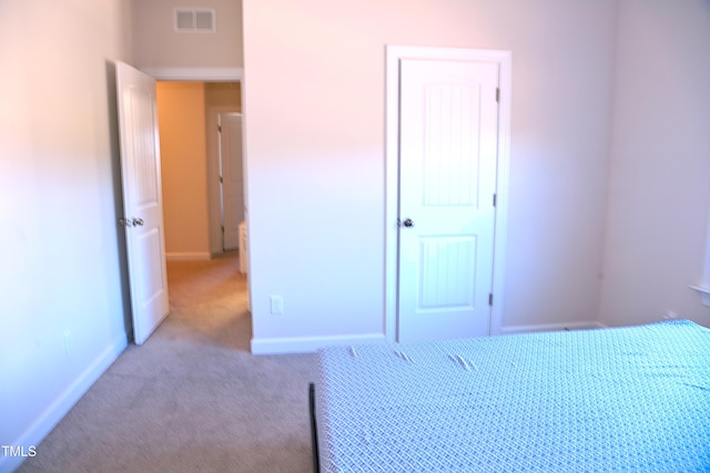 carpeted bedroom with visible vents and baseboards