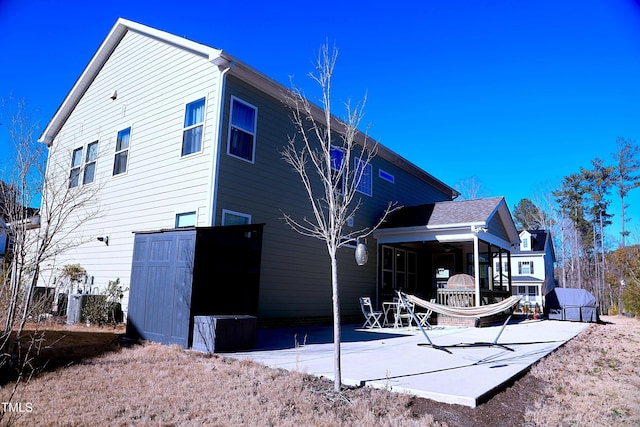 back of property featuring a patio area