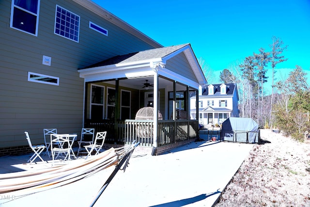 back of house with a ceiling fan, a sunroom, and a patio area