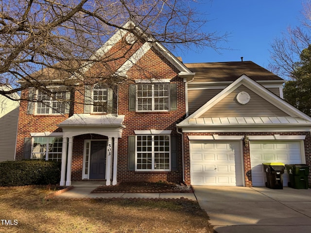 view of front of home with a garage, driveway, and brick siding