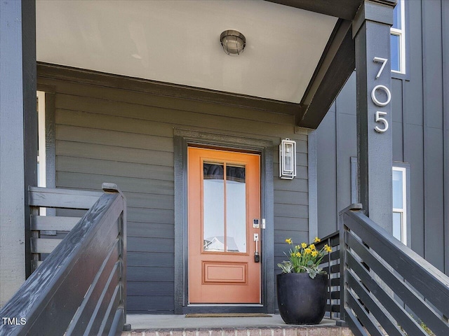 view of exterior entry with board and batten siding