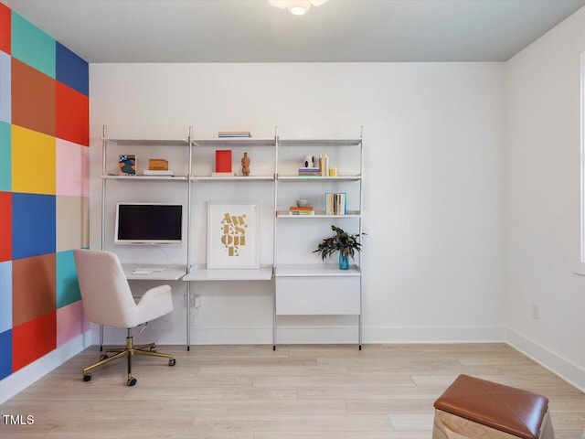 office area featuring baseboards and wood finished floors
