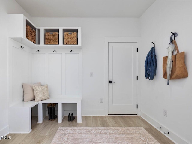 mudroom featuring baseboards and light wood finished floors