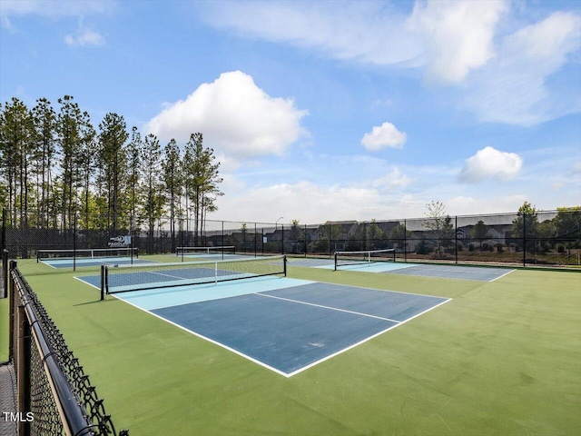 view of tennis court featuring fence