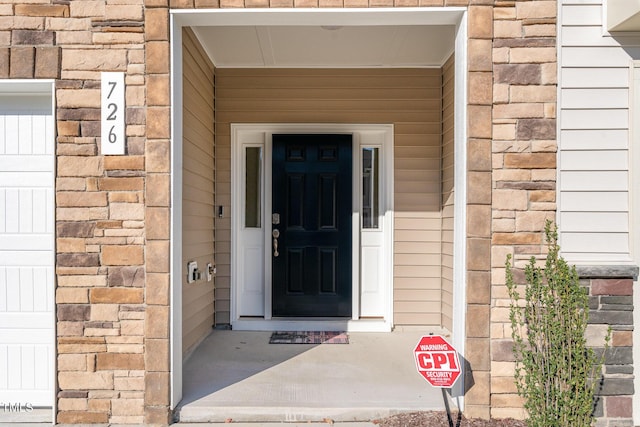 view of exterior entry featuring stone siding