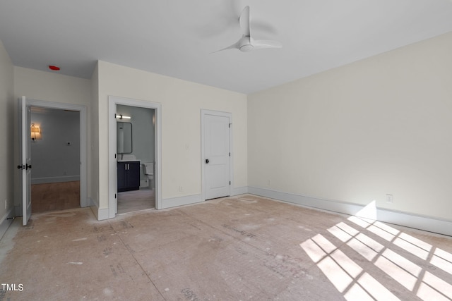 unfurnished bedroom featuring ensuite bath and baseboards