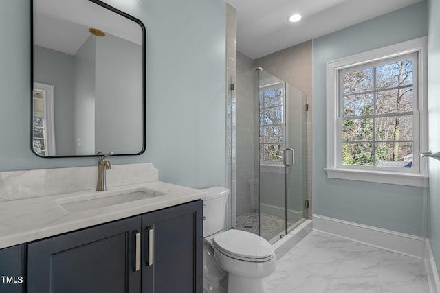 full bathroom featuring marble finish floor, toilet, a stall shower, vanity, and baseboards