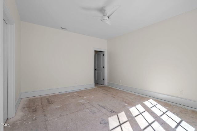 unfurnished room with ceiling fan, visible vents, and baseboards