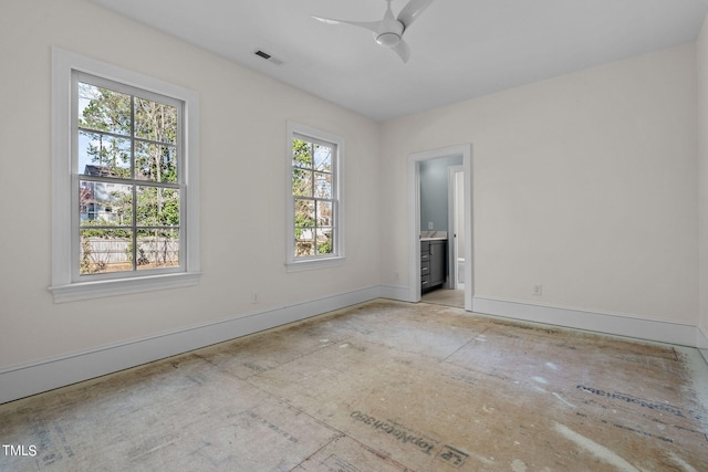 empty room with visible vents, ceiling fan, and baseboards