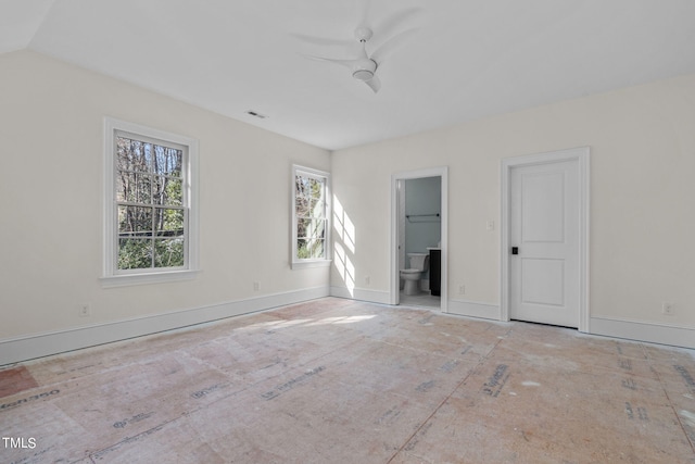 spare room with ceiling fan and baseboards