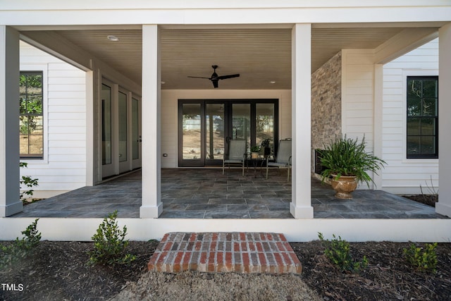 doorway to property featuring a ceiling fan and a patio