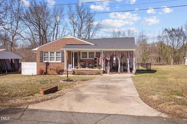 view of front facade featuring driveway, brick siding, crawl space, a porch, and a front yard