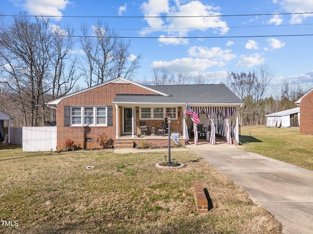 view of front of home with brick siding, crawl space, fence, a carport, and a front lawn