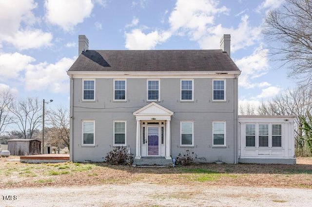 colonial inspired home with a chimney