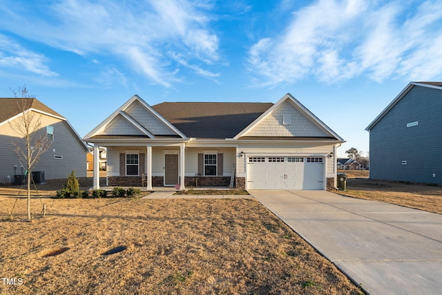 craftsman-style home with an attached garage, stone siding, a porch, and concrete driveway