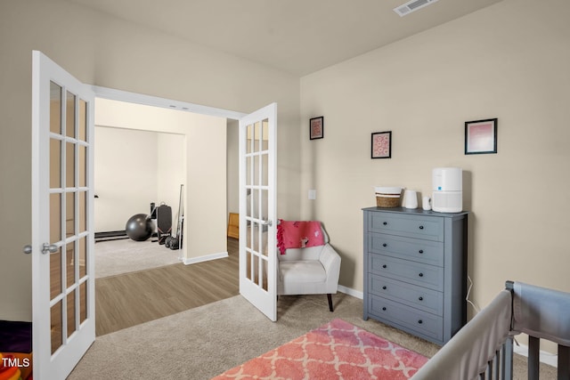 bedroom with carpet flooring, visible vents, baseboards, french doors, and baseboard heating