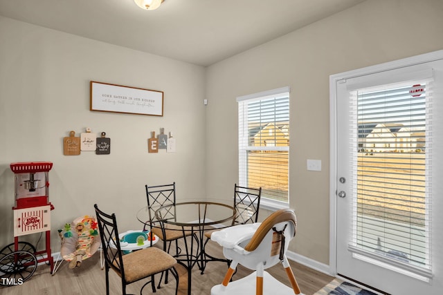 dining room with baseboards and wood finished floors