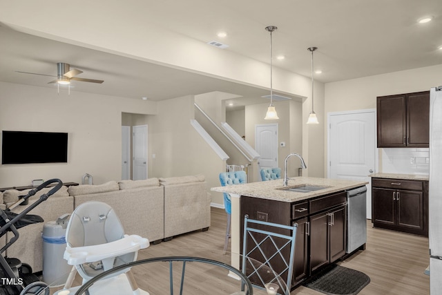 kitchen with light wood-type flooring, visible vents, a sink, and dishwasher