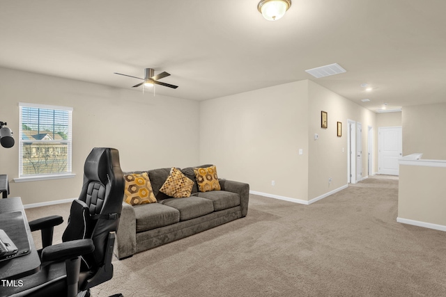 office featuring light carpet, a ceiling fan, visible vents, and baseboards