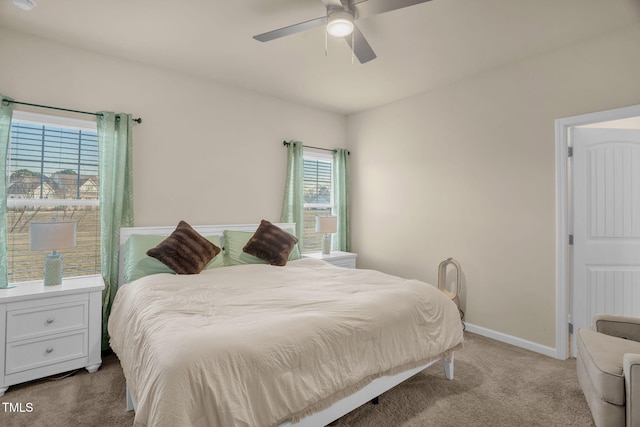 bedroom with a ceiling fan, baseboards, and carpet flooring