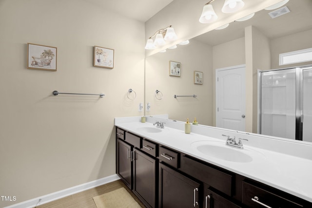 bathroom with double vanity, a sink, visible vents, and a shower stall